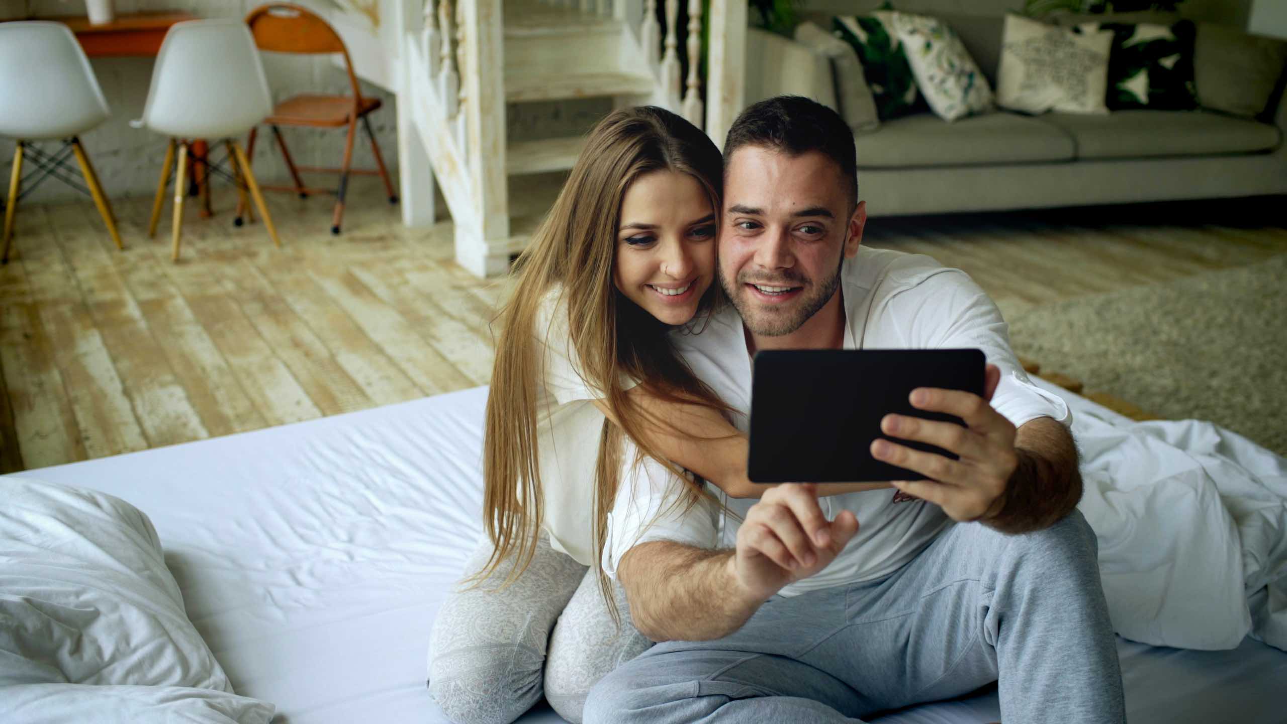 A couple on a video call at home, staying connected with family